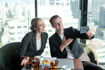 Two business man and woman couple meeting in co working space at sky lounge