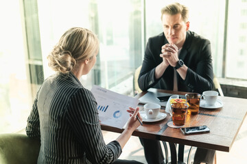 Two businessman and businesswoman couple meeting in co working space or office