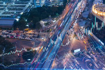 FOREX graph hologram over night busy road traffic in Bangkok, the developed location for stock...