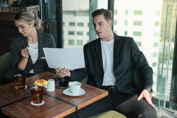 Two businessman and businesswoman couple meeting in co working space or office