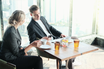 Two businessman and businesswoman couple meeting in co working space or office