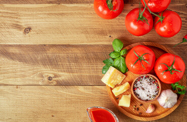 Tomatoes with ingredients for cooking. Italian food concept. Top view, copy space.