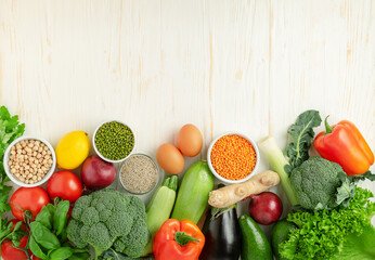 Variety of healthy foods on white wooden background. Top view, copy space. Vegetarian menu