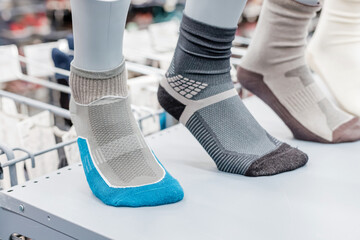 Comfortable sweat-wicking hiking socks on the shelves of a sports store