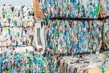 A lot of plastic garbage is compressed by a press and bound into pallets for transportation to a waste processing plant