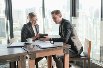 Two businessman and businesswoman couple meeting in co working space or office