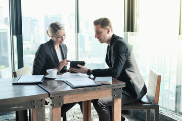 Two businessman and businesswoman couple meeting in co working space or office