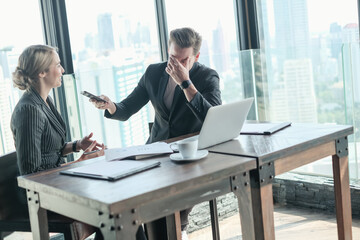 Two businessman and businesswoman couple meeting in co working space or office