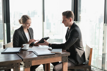 Two businessman and businesswoman couple meeting in co working space or office