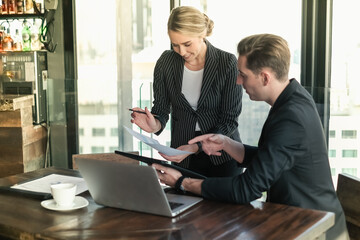 Two businessman and businesswoman couple meeting in co working space at sky lounge