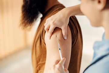 Medicine, vaccination, and healthcare concept. Close up of nurse putting a corona virus vaccine into a patient's arm.