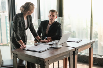 Two businessman and businesswoman couple meeting in co working space at sky lounge