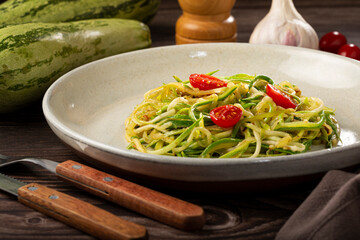 Zucchini spaghetti with tomatoes in garlic and oil.
