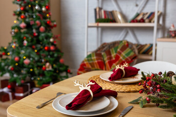 Beautiful table setting with Christmas decor in living room.