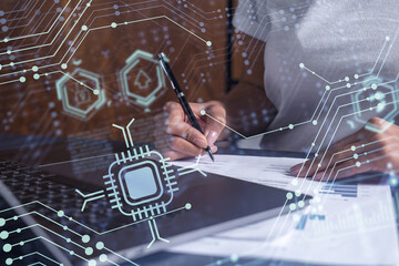 A client is signing a contract to create a new software to present it in start up conference and gain investments to create a product. Technological graph over the desk. Women in business concept.
