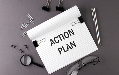 Notebook with Tools and Notes with text ACTION PLAN , business