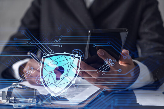 African American businesswoman in formal wear signing the contract to prevent probability of risks in cyber security. Checking the phone. Padlock Hologram icons over the working desk. - Powered by Adobe