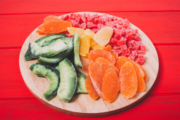 Mixture of dried fruit  on a colorful  wooden background.