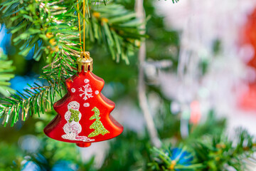 Red bauble decorated on Christmas tree. Ornamented decoration are used to festoon artificial Xmas tree.