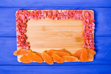 Mixture of dried fruit  on a colorful  wooden background with copy space. View from above.