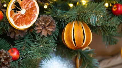 Fototapeta na wymiar Christmas tree decorated with natural materials - slices of dried orange.