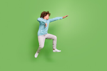 Full length body size view of attractive guy jumping dancing fighting fooling isolated over bright...