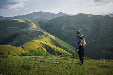 A lonely shepherd on top of a green hill in Dagestan