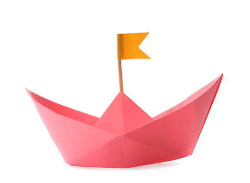 Handmade pink paper boat with orange flag isolated on white. Origami art