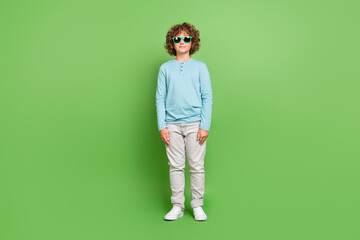 Fototapeta premium Full length body size view of attractive cheery cool guy standing straight isolated over bright green color background
