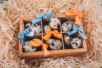 Little raw quail eggs in the wooden box 