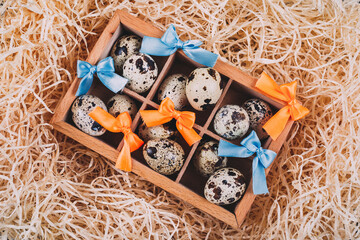 Little raw quail eggs in the wooden box 