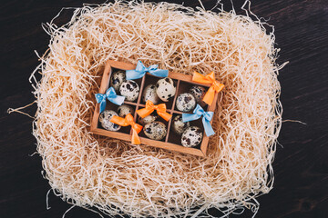 Little raw quail eggs in the wooden box 