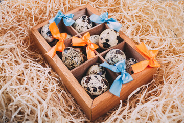 Little raw quail eggs in the wooden box 