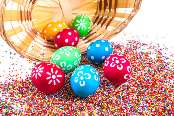 Basket with easter eggs on the background of colored beads