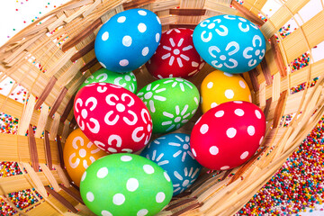 Basket with easter eggs on the background of colored beads