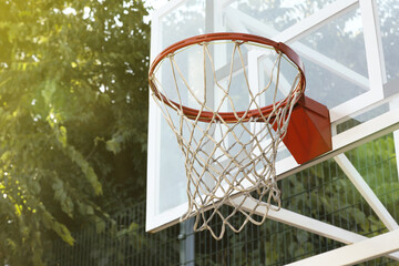 Basketball hoop with net outdoors, space for text