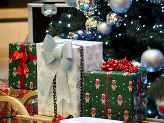 there are packed gifts near the Christmas tree . christmas holidays