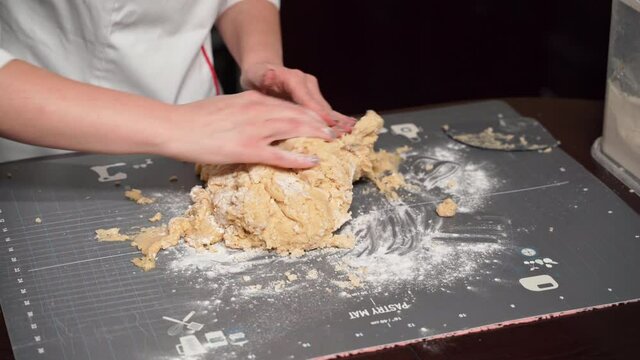 Step-by-step recipe for making honey cake. Confectioner kneads shortbread dough for confectionery