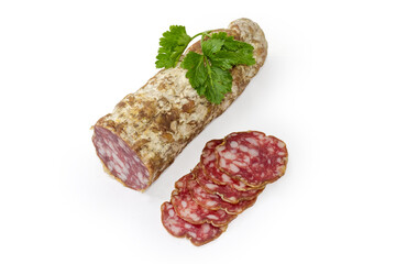 Partly sliced salami with parsley twig on a white background