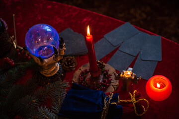 Winter Christmas prediction on a Candle and Tarot cards. Magical esoteric concept. Astrology and...