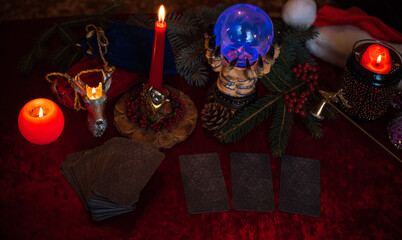 Winter Christmas prediction on a Candle and Tarot cards. Magical esoteric concept. Astrology and...