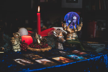 Winter Christmas prediction on a Candle and Tarot cards. Magical esoteric concept. Astrology and...