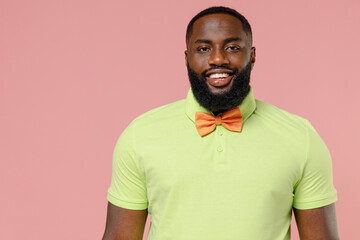 Young smiling happy cheerful satisfied positive stylish black gay man 20s in shirt bow tie celebrate birthday party isolated on plain pastel pink background studio portrait People lifestyle concept