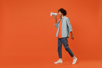 Full body side view young student black man 50s wear blue shirt t-shirt hold scream in megaphone announces discounts sale Hurry up isolated on plain orange background studio. People lifestyle concept.