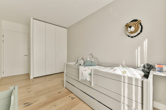 Interior of light children bedroom with bed and toys