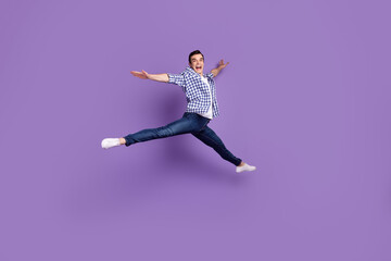 Fototapeta na wymiar Full body profile side photo of young handsome man have fun jump up isolated over violet color background