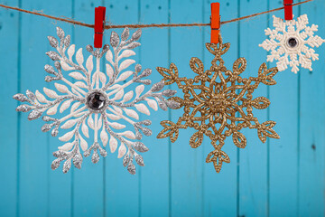 Snowflakes hang on a rope. Christmas card.