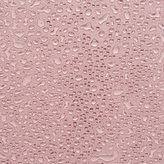 Aesthetic water drops on pink surface