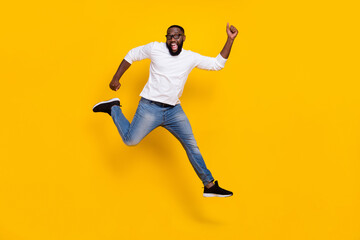 Fototapeta na wymiar Full body photo of excited amazed sporty guy have fun rejoice free time isolated on yellow color background