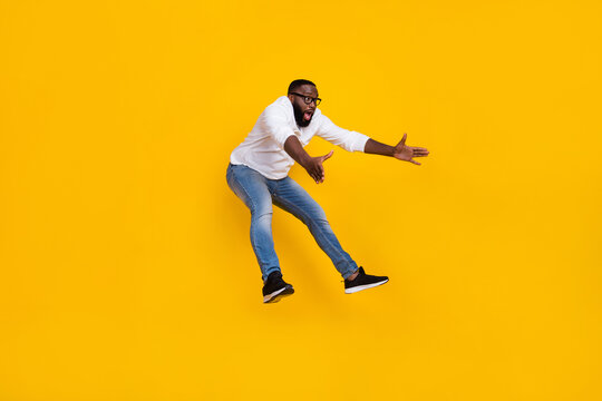 Full size profile portrait of excited impressed person look empty space falling isolated on yellow color background